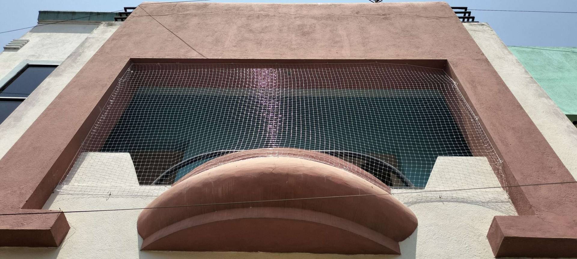 Neatly installed safety nets on a balcony, providing a clean and secure enclosure.